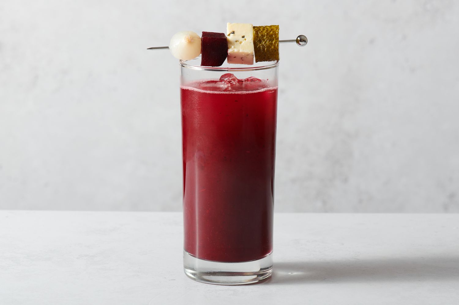 A Bloody Mary garnished with beets and cheese